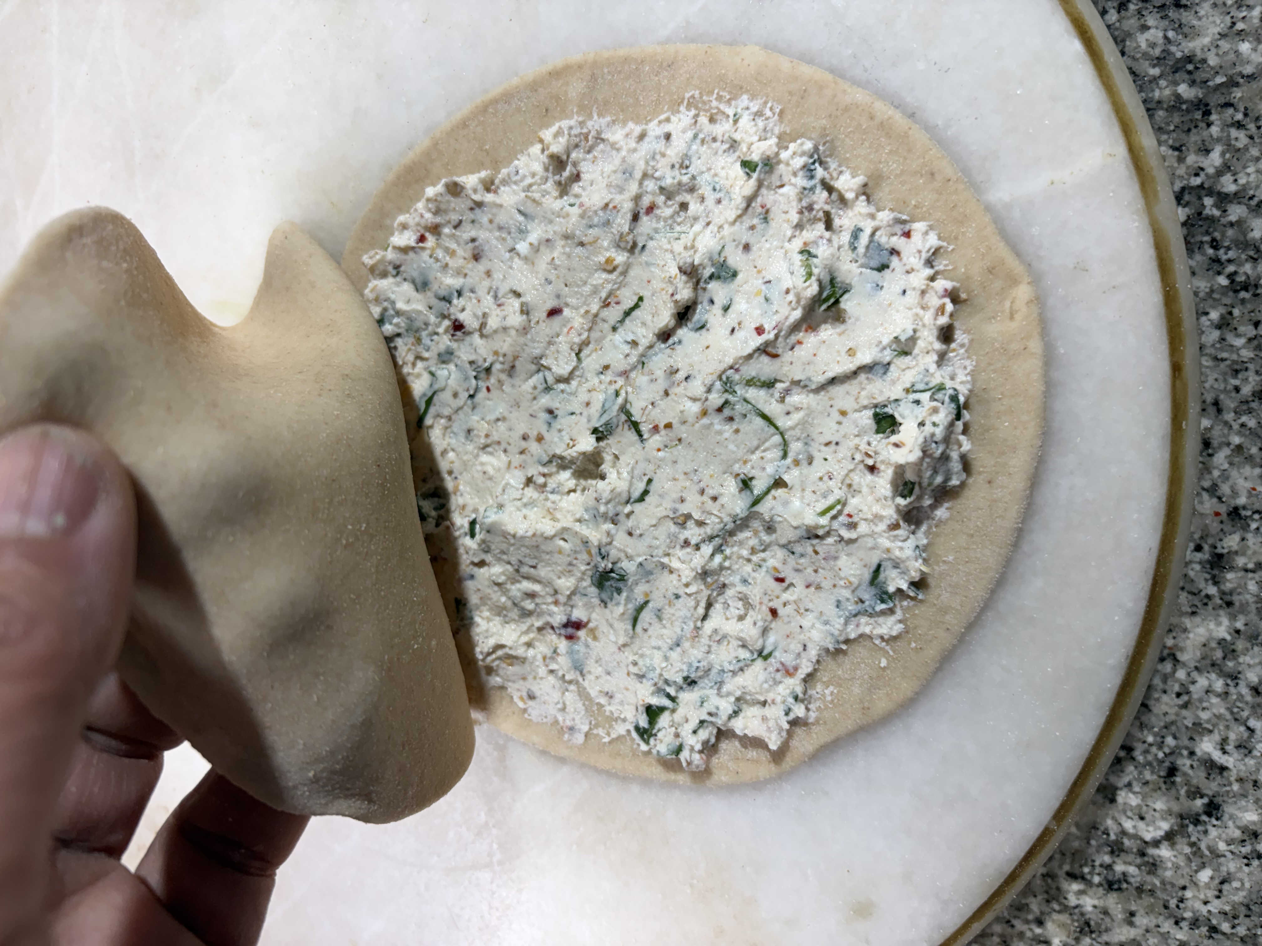 Step 4.1: Spread a generous spoonful of the curd filling evenly over one disc