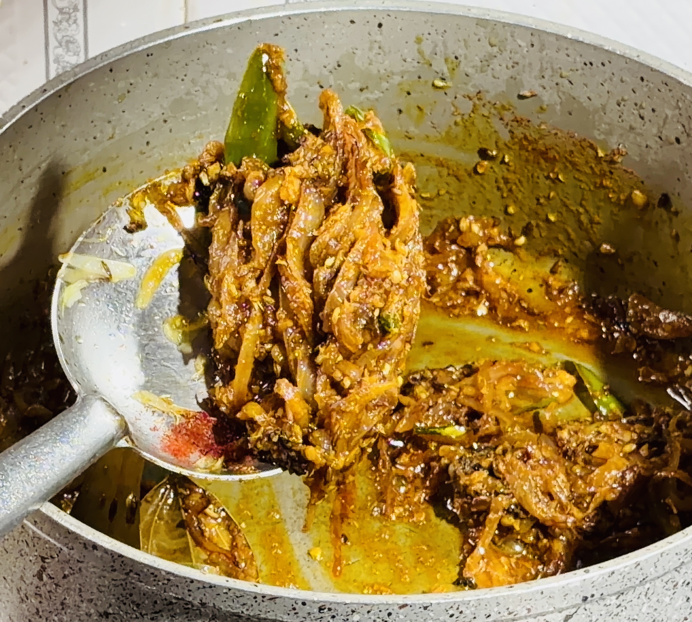Step 3.1: Lower the flame and add turmeric, Kashmiri chilli powder, coriander powder, and cumin powder