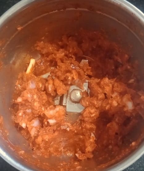 Step 2.1: Add onion, garlic, chilly powder, and salt to a mixer grinder and grind to a coarse paste without adding water