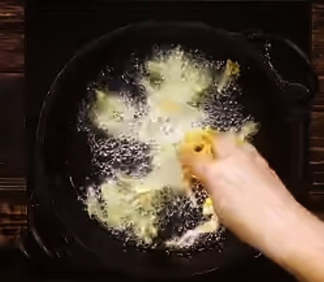 Step 1.2: Take a small portion of the cabbage mixture and gently drop it into the hot oil