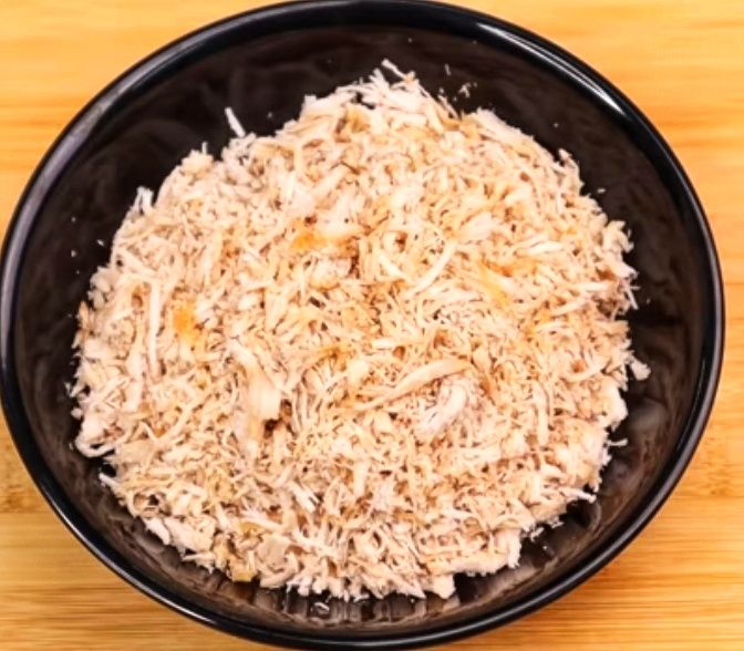 Step 1.1: Transfer the cooled chicken pieces into a chopper or mixer jar and crush them