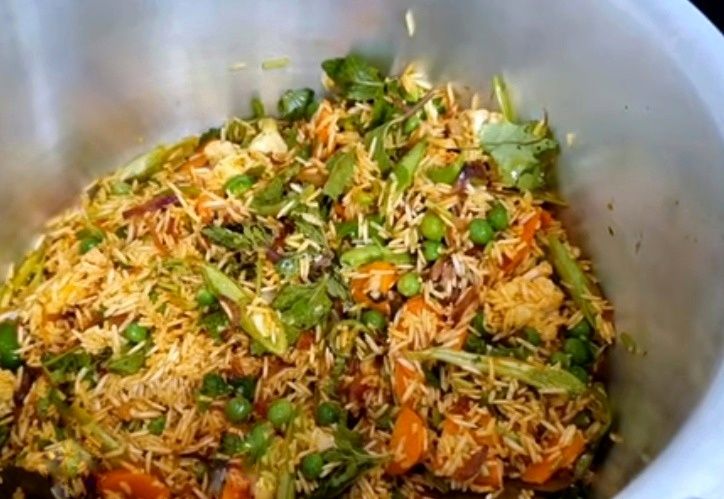 Step 1.1: Add the drained basmati rice along with coriander leaves and mint leaves