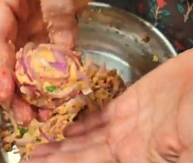 Step 1.1: When the oil becomes hot, take a small ball of the mixture, gently press it with your hands to make a vada shape, and drop it into the hot oil