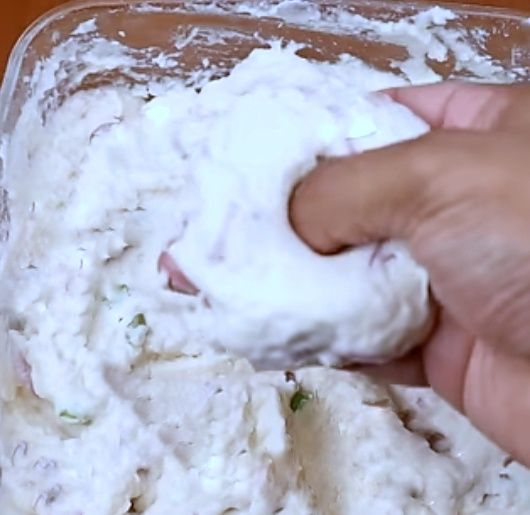 Step 2.1: Wet your palm, scoop a small ball of batter, gently flatten it, and make a hole in the center like a doughnut