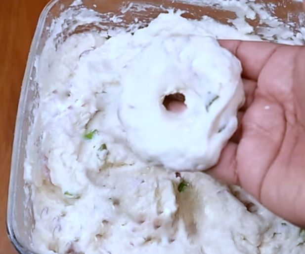 Step 2.2: Wet your palm, scoop a small ball of batter, gently flatten it, and make a hole in the center like a doughnut