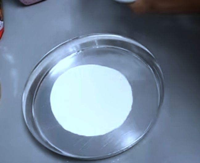 Step 1.2: Grease a steel plate with some ghee and pour 2-3 tbsp of batter onto it (quantity of batter depends on the size of the plate)