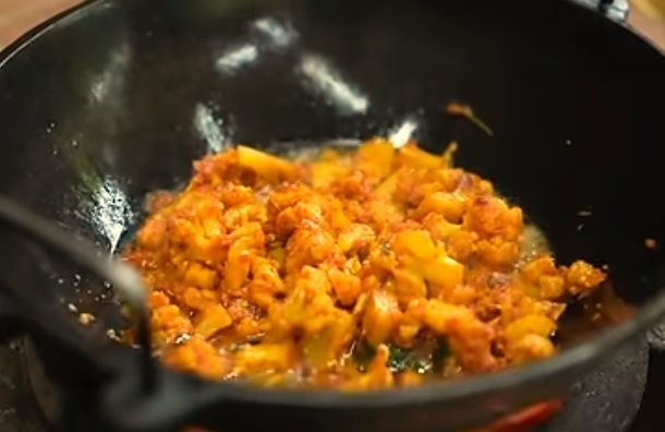 Step 2.1: Heat coconut oil in a pan, and when hot, add the marinated cauliflower