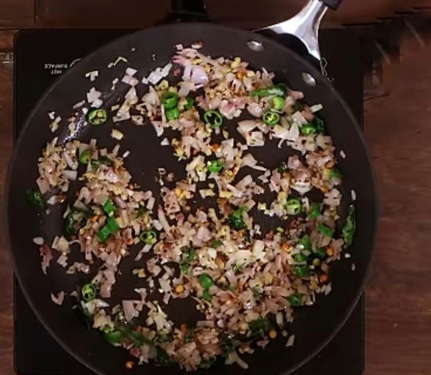 Step 3.1: Add urad dal, curry leaves, green chilies, and sliced onions