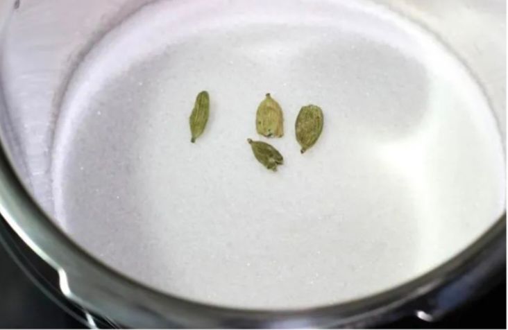 Step 2.1: In a pot, mix sugar, water, cardamom, and saffron