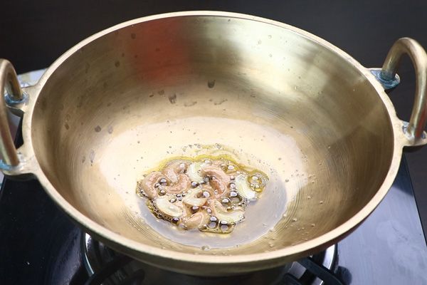 Step 2.1: Heat ghee, add cashews, and fry until golden brown