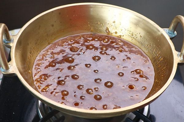 Step 2.2: Add strained jaggery syrup and cook until the syrup is thick, about 10 minutes