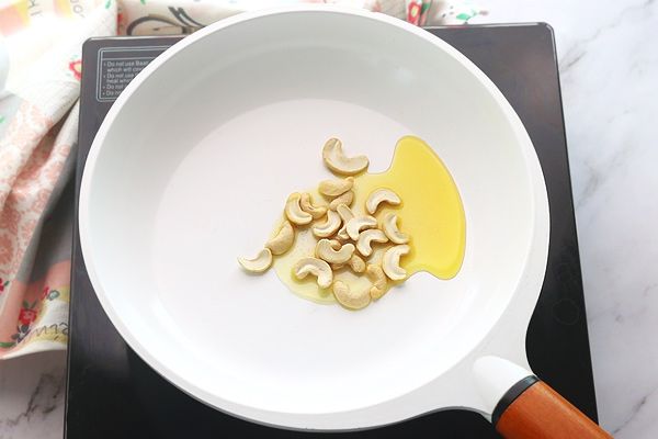 Step 1.1: Heat ghee in a pan and add cashews