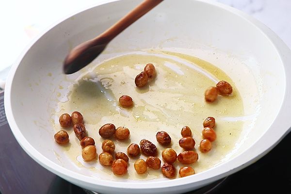 Step 1.1: Add raisins to the same pan and fry until they bubble up and are golden in color