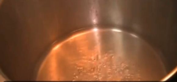 Step 5.3: When the water in the pot starts boiling, add a base to support the wraps (you can use the Uma leaf stalks or a stainless-steel base)