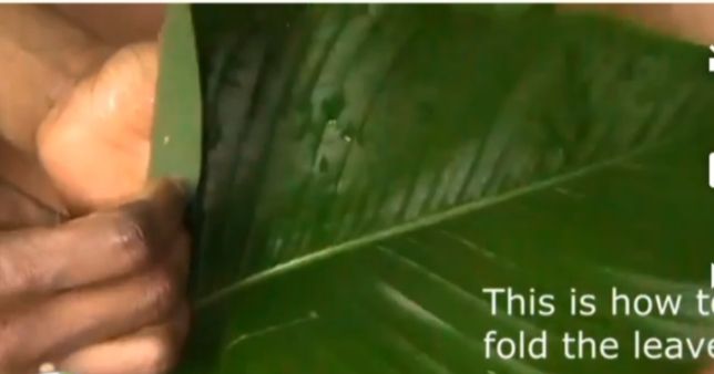 Step 5.3: Begin folding the Uma leaves and scoop the plantain moi moi mixture into each leaf wrap, one by one