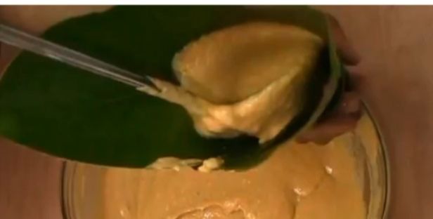 Step 5.4: Begin folding the Uma leaves and scoop the plantain moi moi mixture into each leaf wrap, one by one