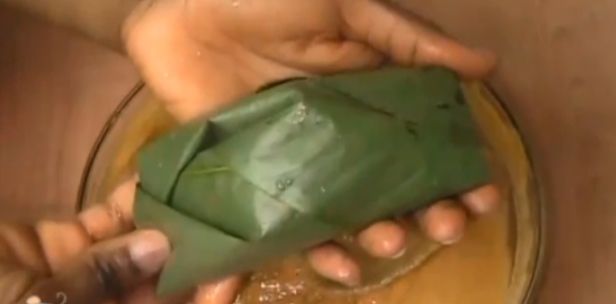 Step 5.6: Begin folding the Uma leaves and scoop the plantain moi moi mixture into each leaf wrap, one by one