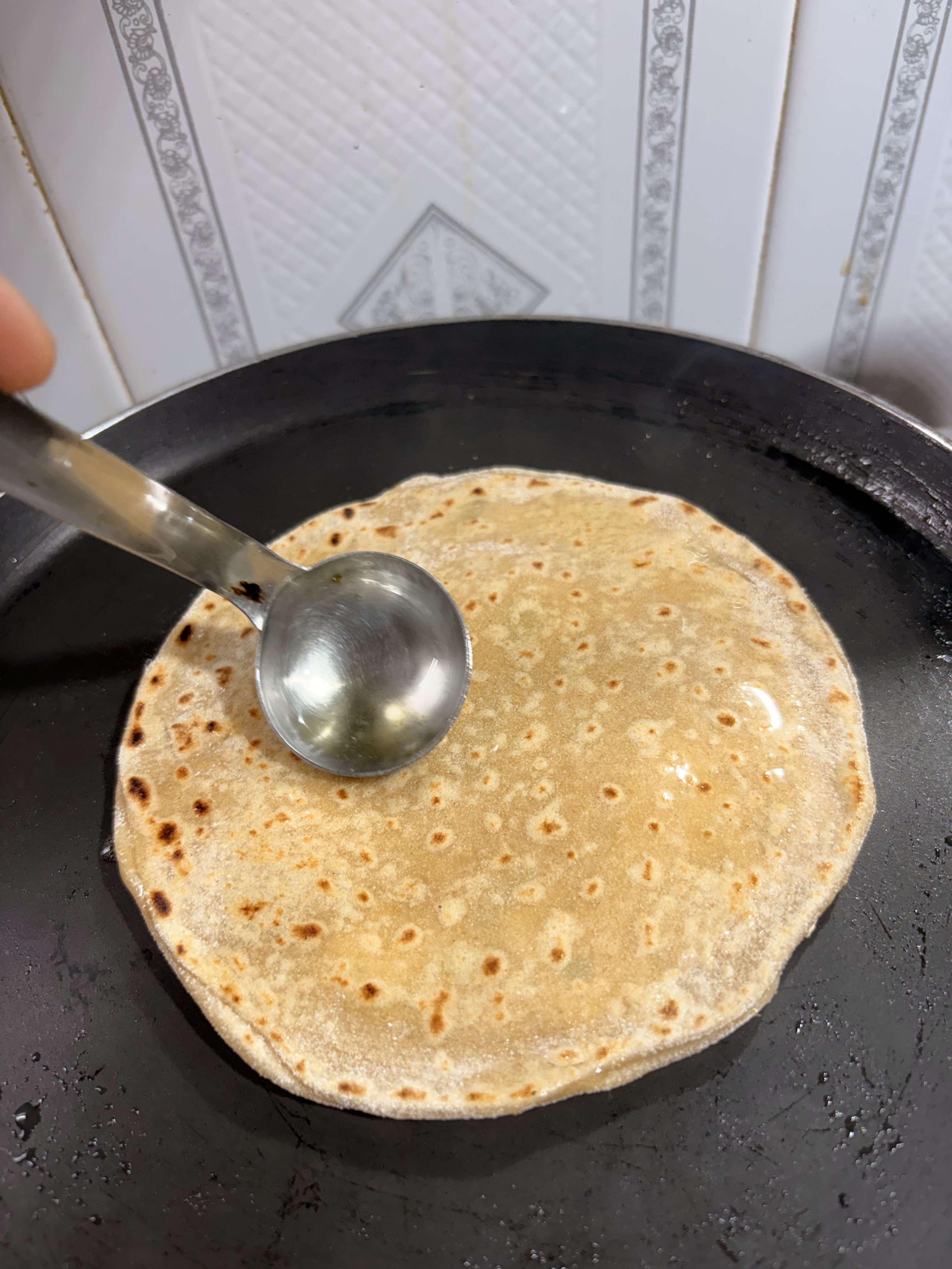Step 5.1: Flip, brush lightly with oil or ghee if desired, and cook both sides until golden and crisp