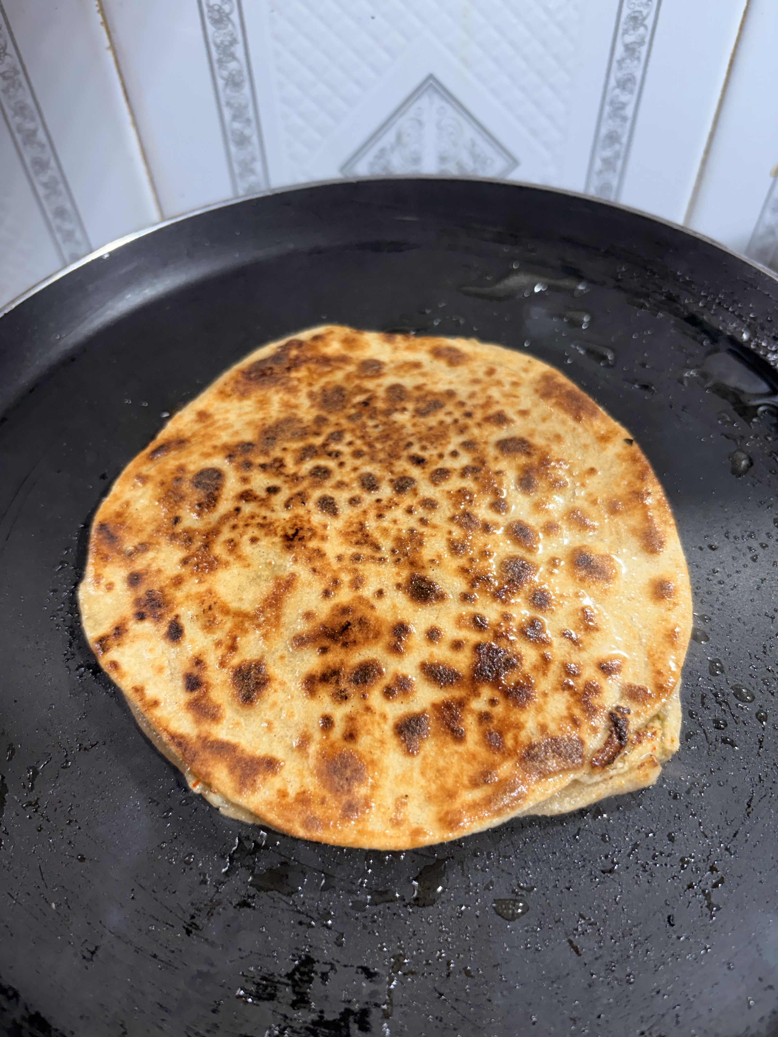 Step 5.2: Flip, brush lightly with oil or ghee if desired, and cook both sides until golden and crisp