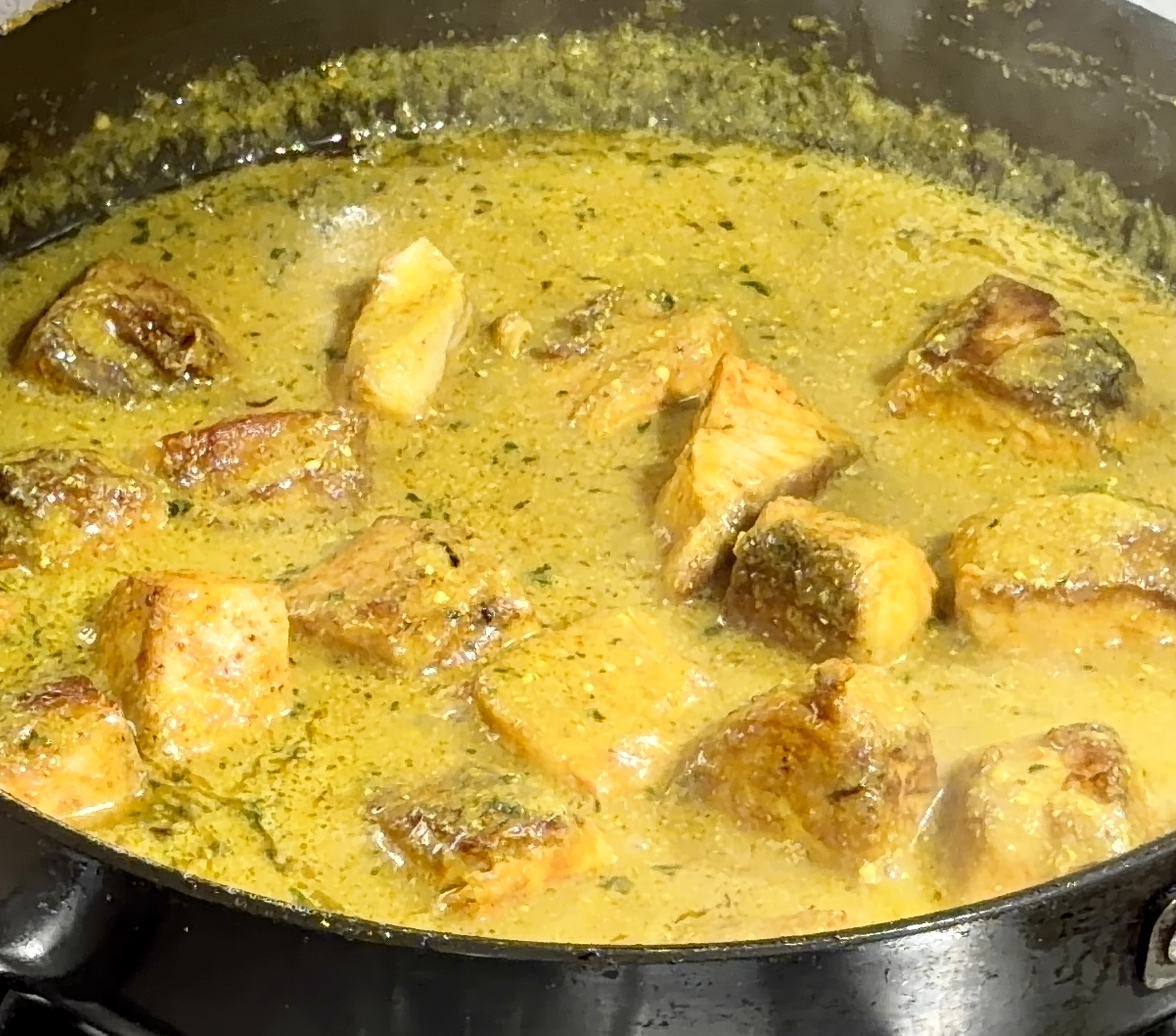 Step 4.1: Cover and simmer on low heat for 8–10 minutes, or until the fish is fully cooked and oil surfaces on top