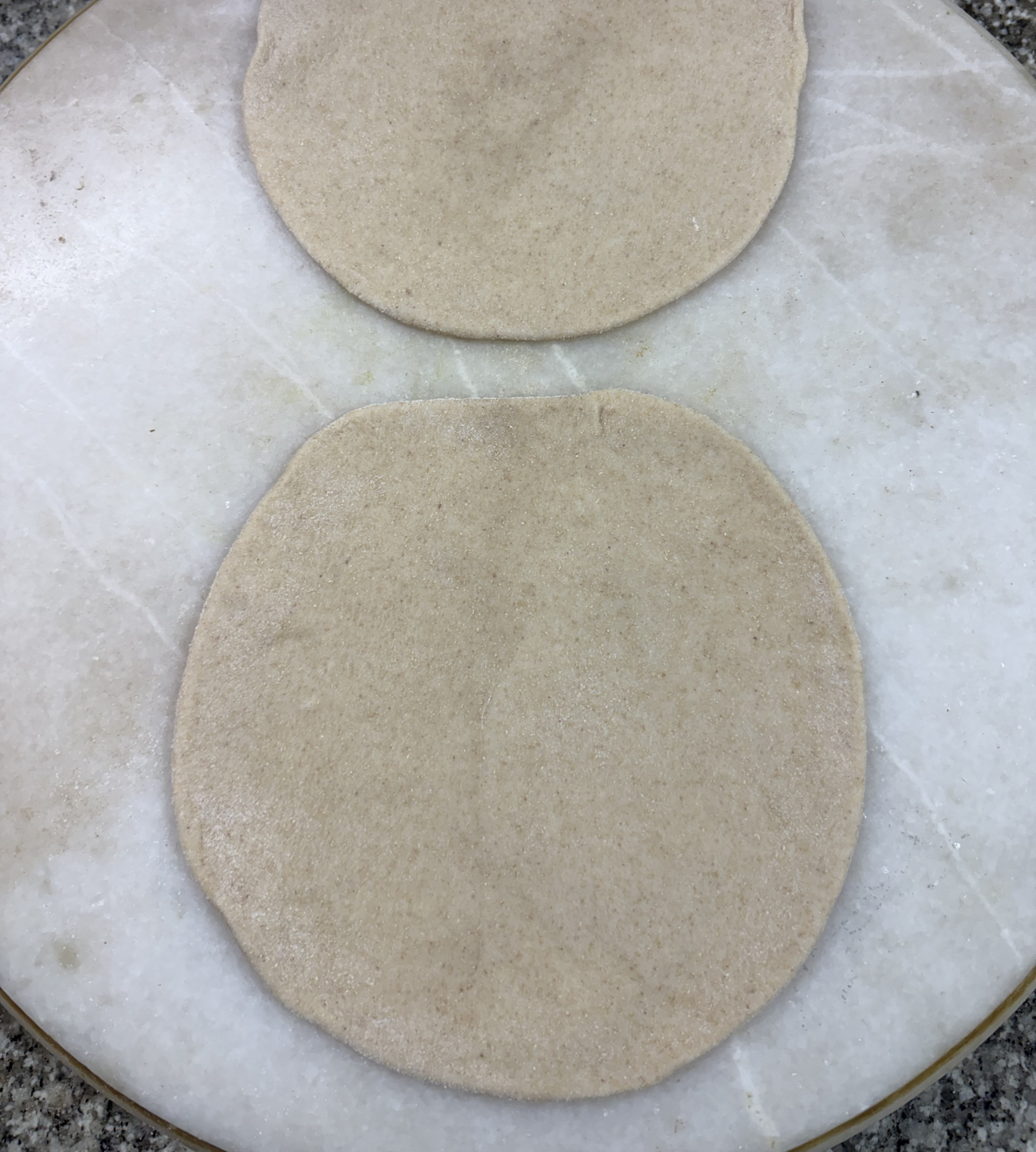 Step 4.1: Dust two balls with flour and roll them into small discs