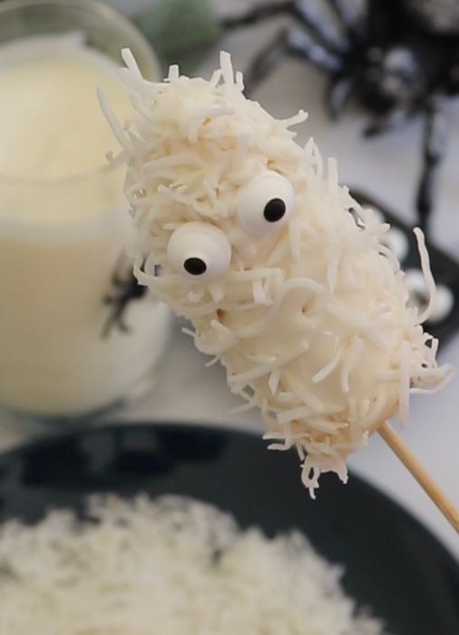 Step 1.1: Press two candy eyes onto each banana pop to give them a spooky face