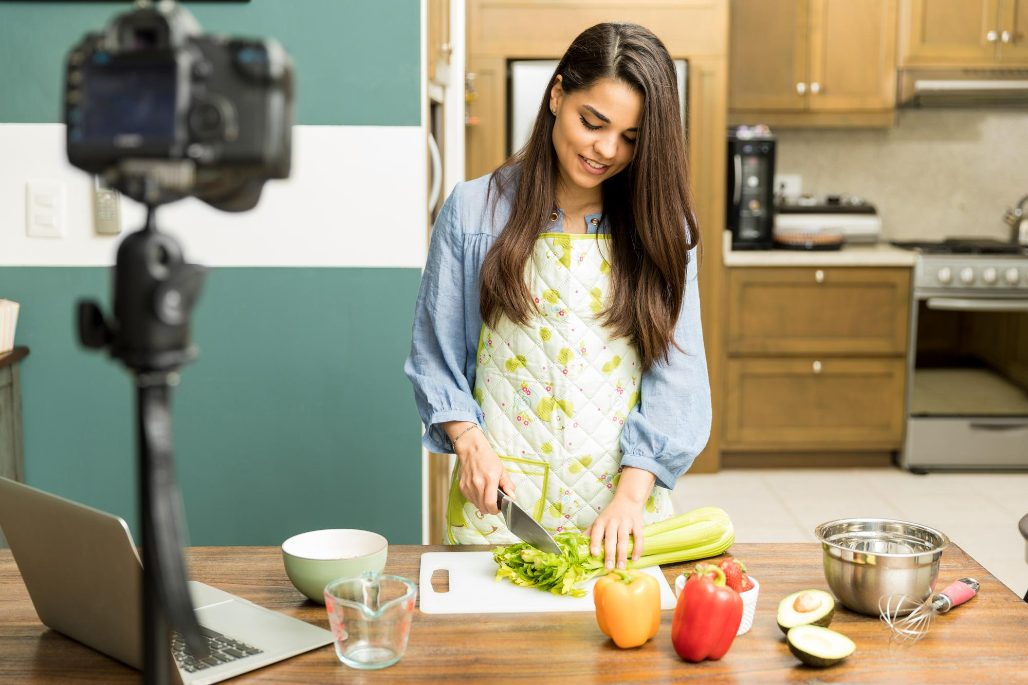 food content creator preparing a recipe and filming in a home kitchen