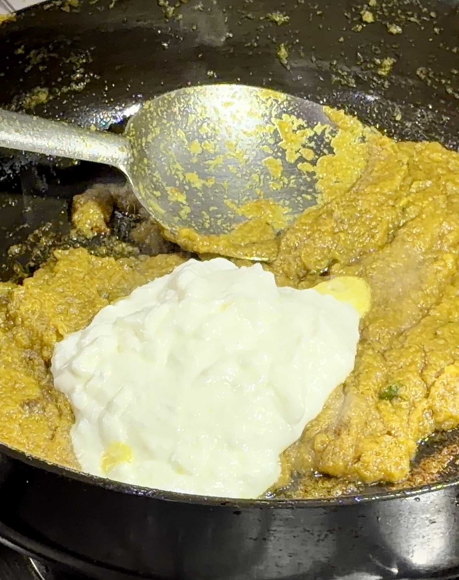 Step 4.1: Lower the heat and slowly add the whisked curd, stirring continuously to prevent splitting