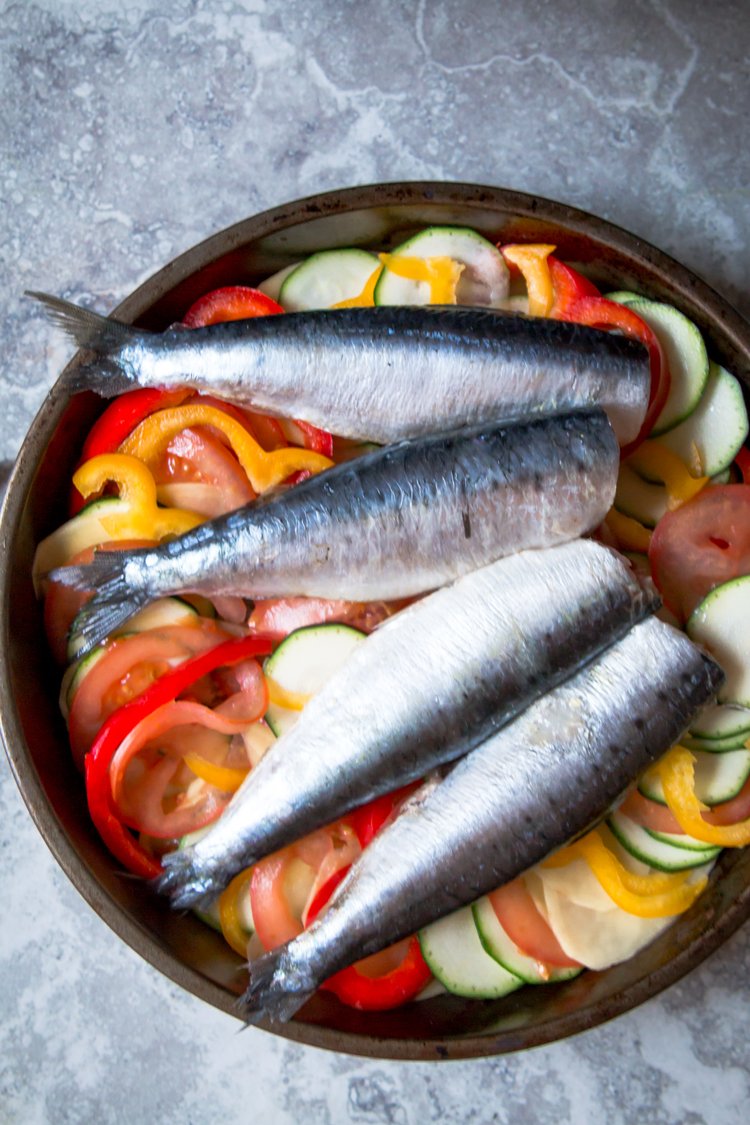 Step 1.1: Arrange the refrigerated sardines on top of the vegetables and top with lemon slices