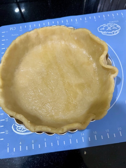 Step 1.1: Press the chilled dough into the removable base tart pan