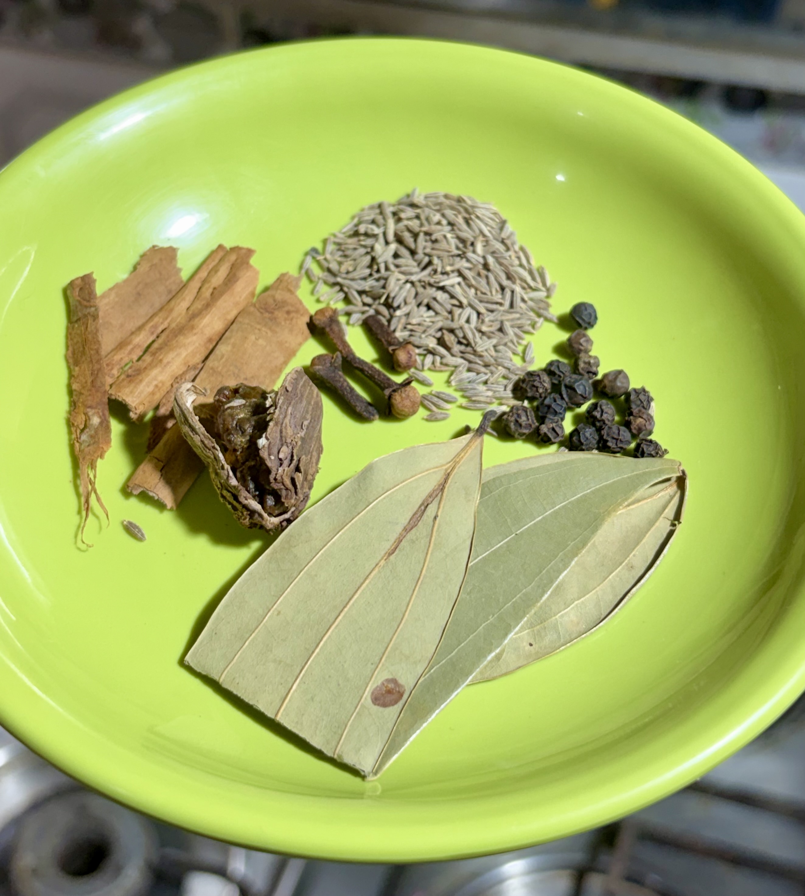 Step 3.1: Lower the heat, and add cumin seeds, cinnamon, bay leaves, peppercorns, black cardamom, and cloves