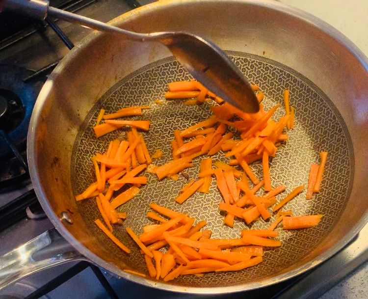 Step 1.1: Add one more teaspoon of oil to the pan, add the sliced carrots, and saute for 2-3 minutes
