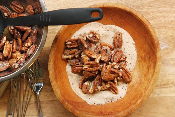 Step 4.1: Using a slotted spoon, lift coated pecans into the sugar mixture