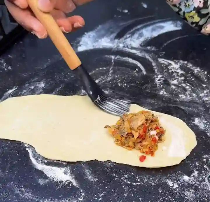 Step 3.3: Use a brush to apply slurry all around the edges of the dough