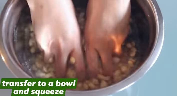 Step 1.2: Transfer the soaked beans to a bowl and squeeze them to loosen the peels