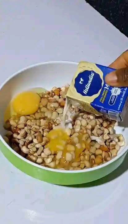 Step 1.6: In a bowl, add little water, properly washed beans, evaporated milk or coconut milk, peeled onion halves, red shombo peppers, and eggs