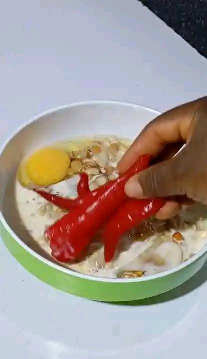 Step 1.1: In a bowl, add little water, properly washed beans, evaporated milk or coconut milk, peeled onion halves, red shombo peppers, and eggs