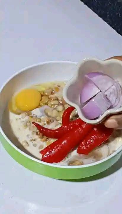 Step 1.2: In a bowl, add little water, properly washed beans, evaporated milk or coconut milk, peeled onion halves, red shombo peppers, and eggs