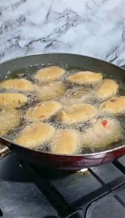 Step 1.4: Heat oil in a pan and scoop the mixture using a deep tablespoon