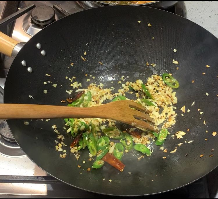 Step 3.1: Add dry red chillies, chopped ginger, garlic and bullet chillies to the wok