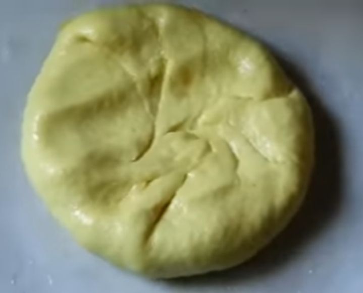 Step 1.1: Place a spoonful of the toor dal mixture in the center of the flattened dough and seal the edges to form a ball