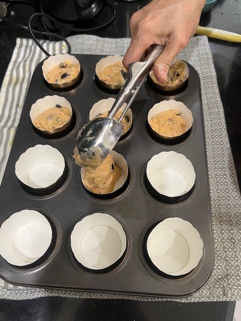Step 6.2: Spoon the batter into the prepared muffin tin, filling each cup about ¾ of the way