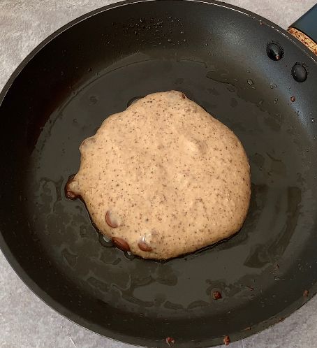 Step 1.1: Using a 1/2 cup measure or a spoon ladle, scoop the batter onto the skillet and slightly press down with a spatula to flatten it to a pancake shape
