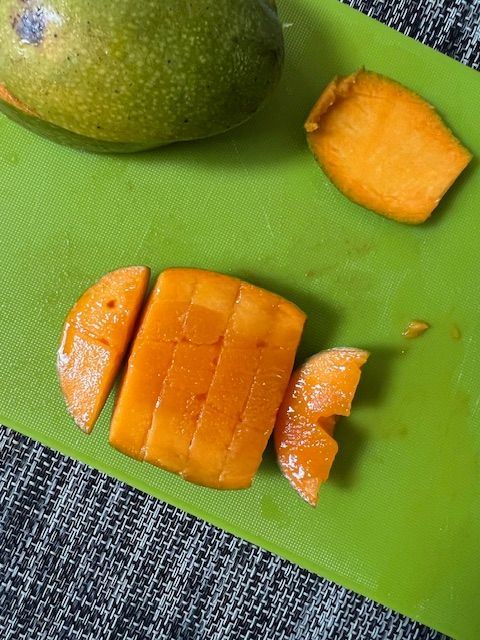 Step 2.2: For the fish (mango): Slice off mango cheeks