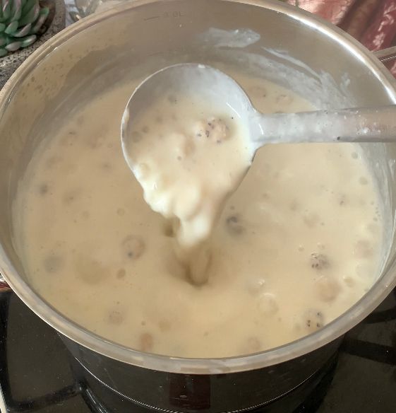 Step 1.2: Add the roasted and ground makhana, and desiccated coconut to the simmering milk
