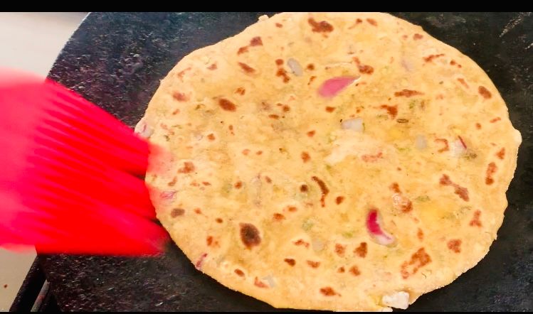 Step 1.1: Brush the paratha with some oil, flip it again, and press gently with a flat spoon until lightly golden