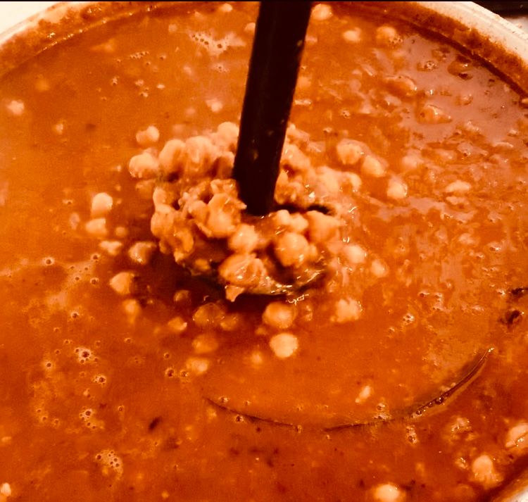 Step 2.1: Mash some chickpeas gently with a masher and bring the mixture to a boil