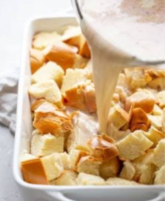 Step 1.1: Pour the milk mixture evenly over the bread cubes