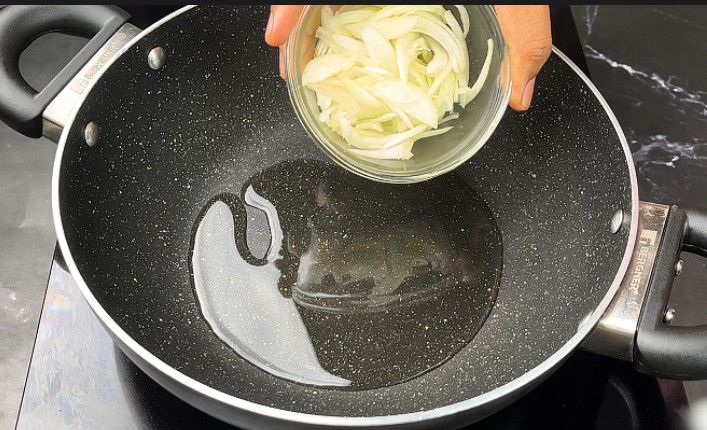 Step 1.2: In a pan, heat oil and sauté the sliced onion and ginger garlic paste