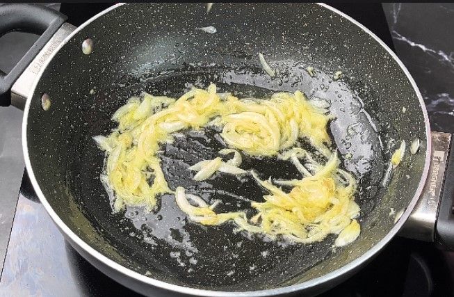 Step 1.6: In a pan, heat oil and sauté the sliced onion and ginger garlic paste